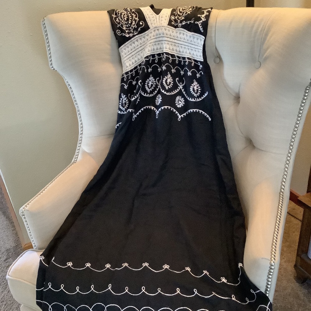 Embroidered black halter dress.